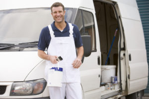 Painter standing with van