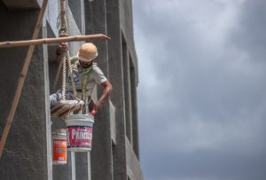 man working on a building’s exterior