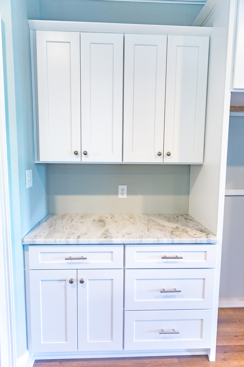White cabinets and granite gray marble countertop in a new construction kitchen
